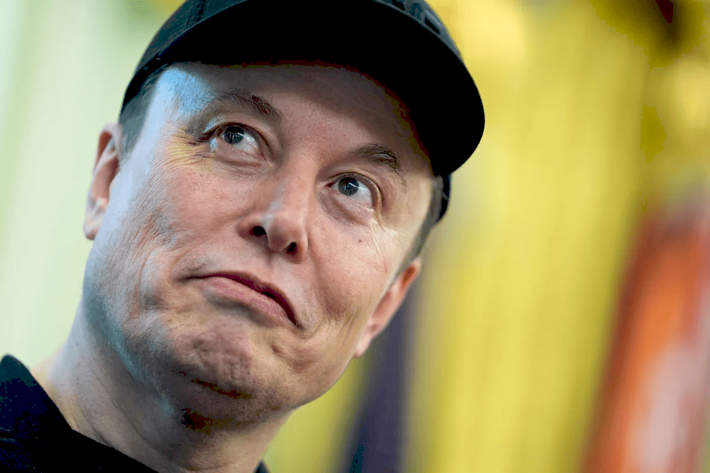 Ілон Маск на фоні Tesla